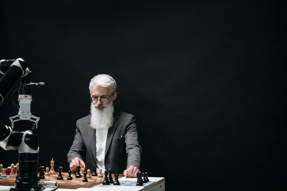 Man in Black Suit Jacket Playing Chess