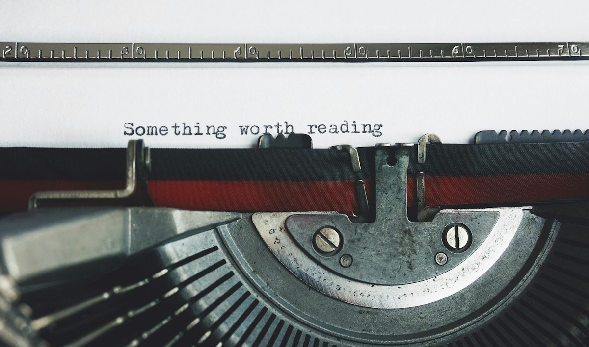 Black and Red Typewriter on White Table