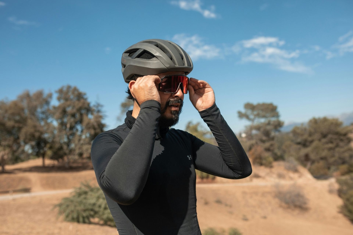 A Man in Long Sleeve Jersey Wearing a Helmet and Sunglasses