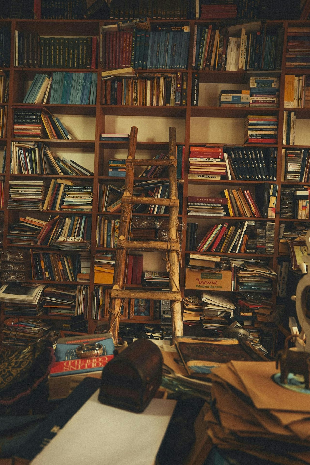 A room full of books and a ladder