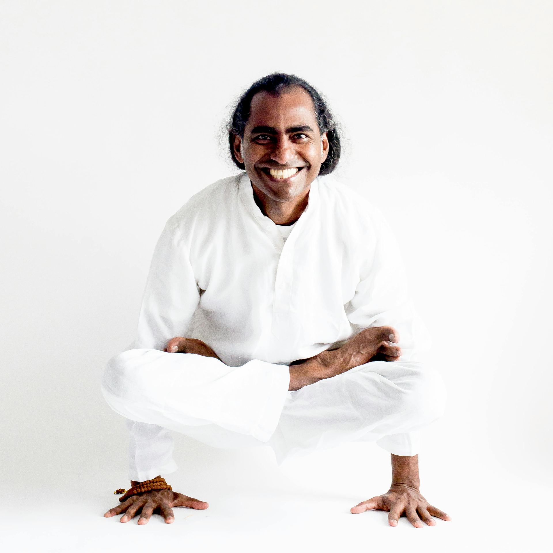 A Man in White Long Sleeves Doing Yoga