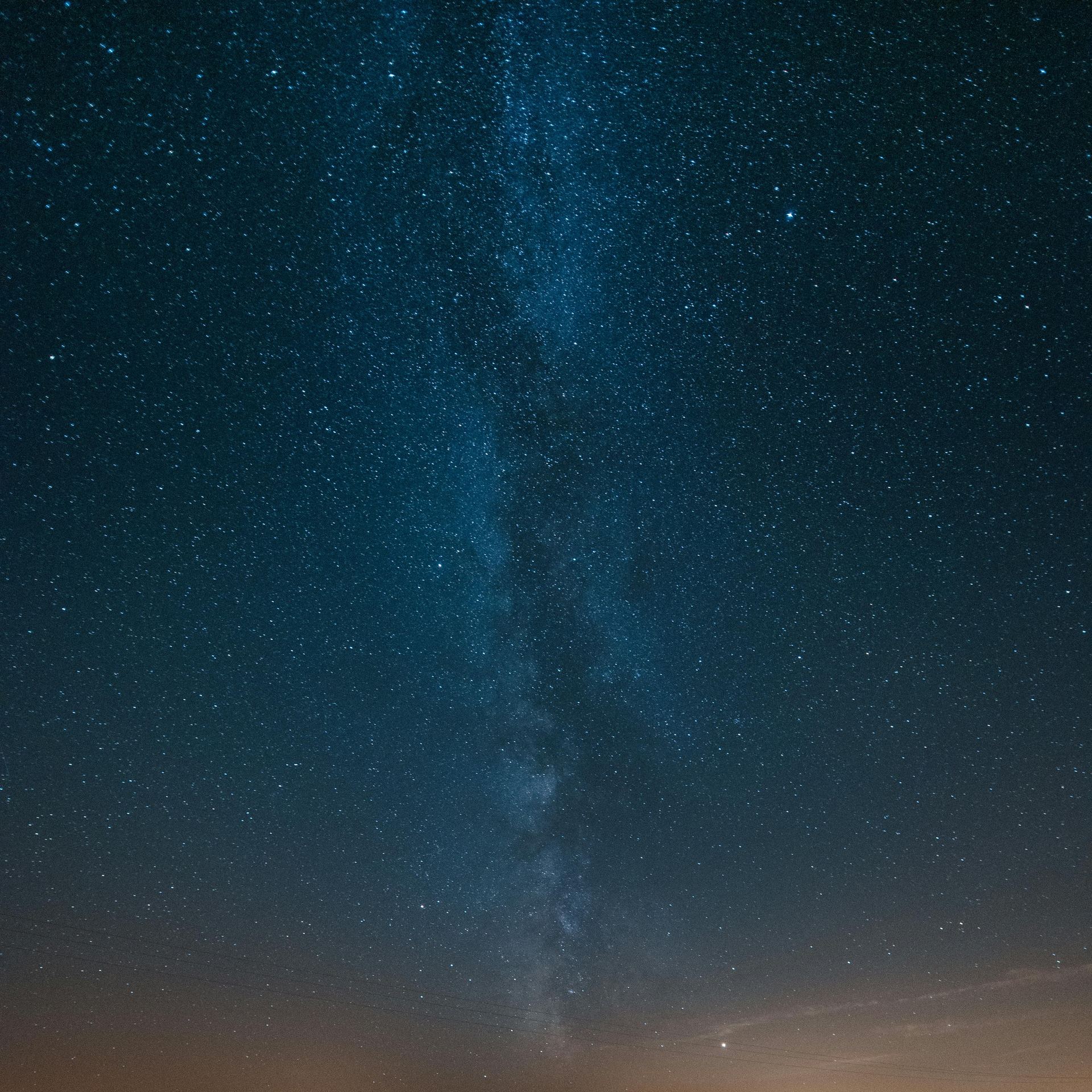 From below of bright night sky with shining stars and Milky Way galaxy