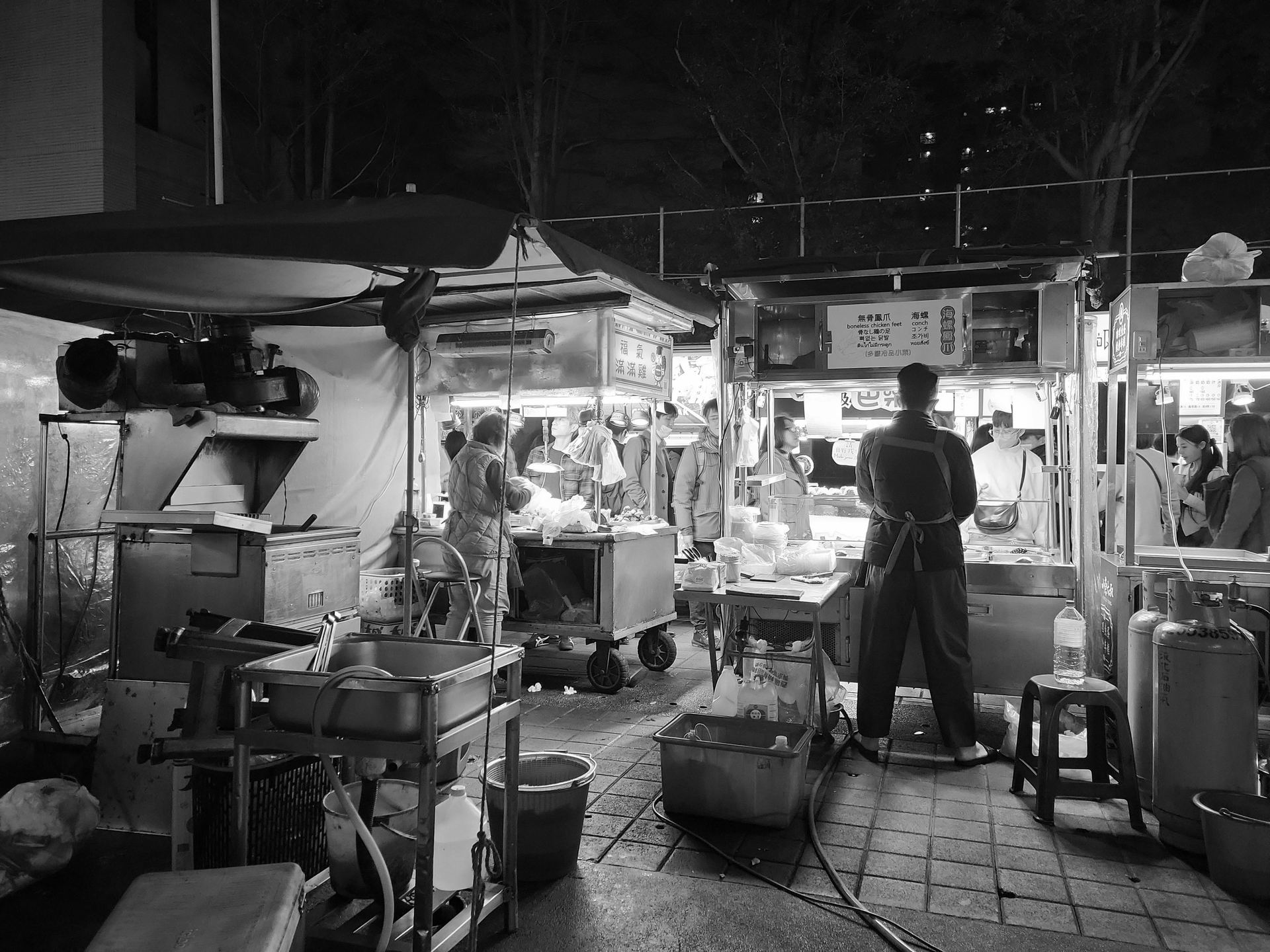 A black and white photo of a food stand