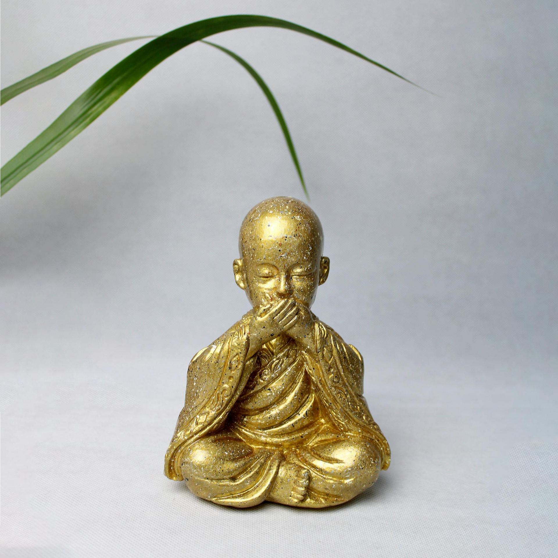 Gold Buddha Figurine on White Surface